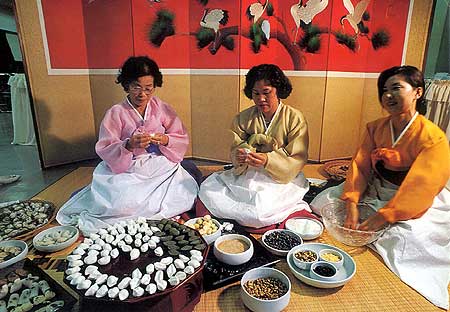 Корейские женщины по случаю праздника урожая заняты приготовлением  сонпхен, рисовых пирожков